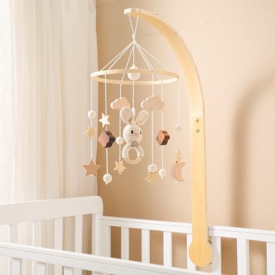 Gentle wooden baby mobile with plush bunny, stars, moons, clouds, and hanging decorative elements for nursery decor.
