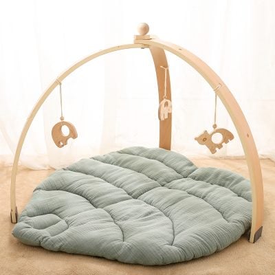 Soft baby play mat with wooden arch and hanging plush toys, ideal for infant sensory development and playtime.