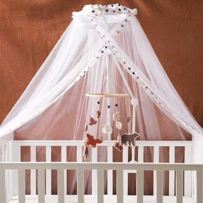Soft white baby cot with canopy and hanging felt animal mobile, ideal for nursery decoration and infant sleep, perfect for creating a cozy nursery environment.