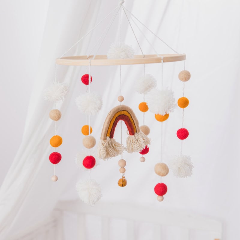 Colorful Boho Baby Mobile with Rainbow and Pom Balls, soft neutral tones, ideal for nursery decor, handmade, playful design for infants and toddlers.