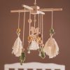 Handmade baby crib mobile with wooden and felt elements, soft tassels, and playful animal figures for nursery decor.