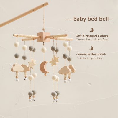 Wooden baby crib mobile with clouds, stars, moon, and felt balls in natural colors for infants.