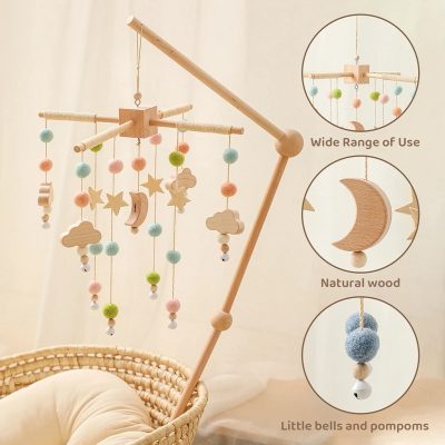 Soft pastel baby mobile with wooden clouds, stars, crescent moon, and felt balls for nursery decor. Features natural wood, wide use, and gentle hanging bells for calming baby.