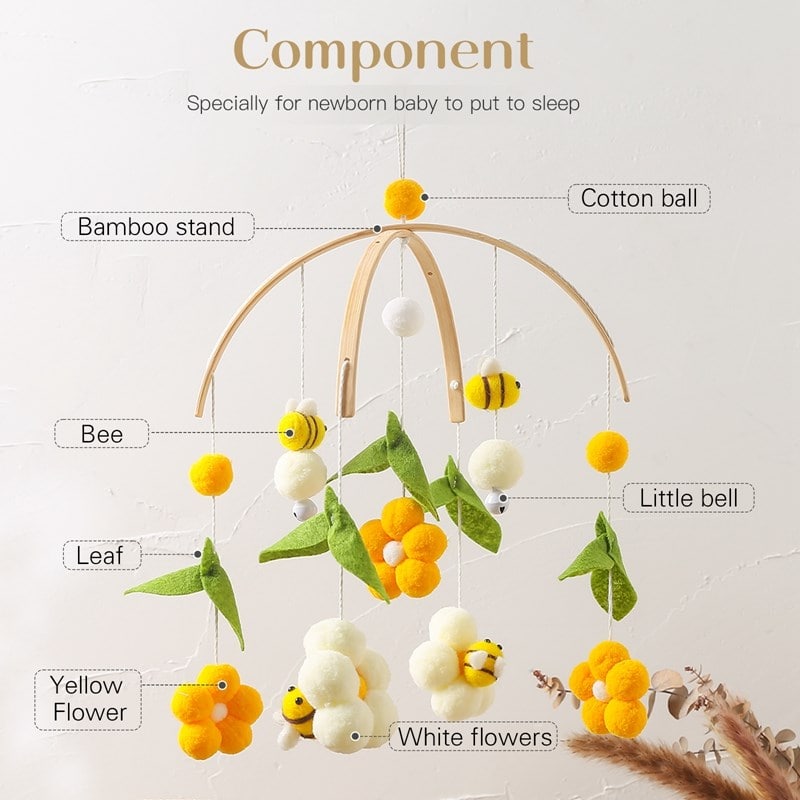 Soft baby mobile for nursery decor featuring felt bees, white and yellow flowers, cotton balls, and bamboo stand, perfect for calming newborns and infants.