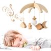 Wooden baby crib mobile with stars, clouds, moon, and musical notes for nursery decor.