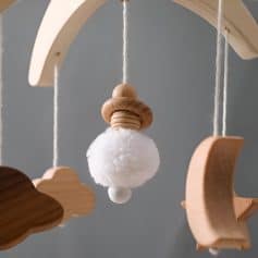 Soft baby mobile with wooden clouds, moon, and star for nursery decor, perfect for calming infants and promoting visual development, available at Monalisa Store.
