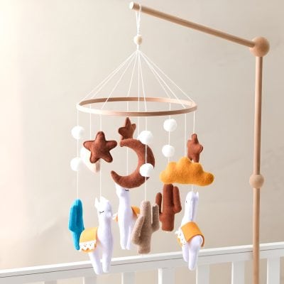 Soft felt baby mobile featuring stars, moons, and animals, perfect for nursery decor, promoting visual development and calming ambiance for infants.