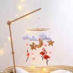 Whimsical baby mobile with plush clouds, crescent moon, stars, and flamingos, perfect for nursery decor and infant sleeping comfort. Soft pastel colors create a calming environment for babies.
