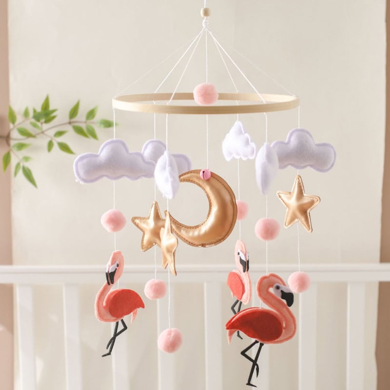 Golden moon and star plush mobile for nursery decor with pink flamingo accents and cloudy felt clouds, perfect for infant bedrooms and sensory development.