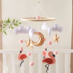 Cloud and moon nursery mobile for baby room decor, plush flamingo and star accents, soft pastel colors, ideal for a soothing sleep environment, perfect for a nursery or infant room decor.
