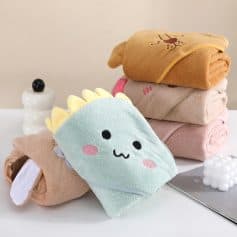 Fluffy dinosaur towel with cute face and cartoon scales, pastel-colored stack of towels with animal designs, cozy hotel bath linen, Monalisa Store opt towel collection, plush reversible bath towels for kids and adults.