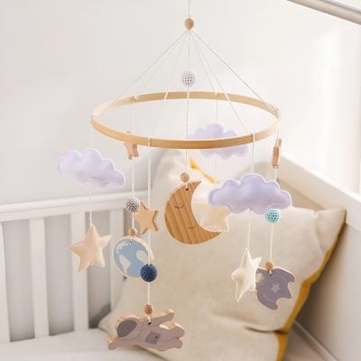 Soft pastel baby cradle mobile with clouds, moons, stars, and animals, ideal for nursery decor and promoting visual development in infants. Perfect for a calming and soothing environment.