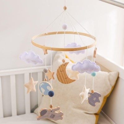 Soft pastel baby mobile with cloud, moon, star, and animal plush accents for nursery decor, ideal for calming infants and enhancing nursery aesthetics.