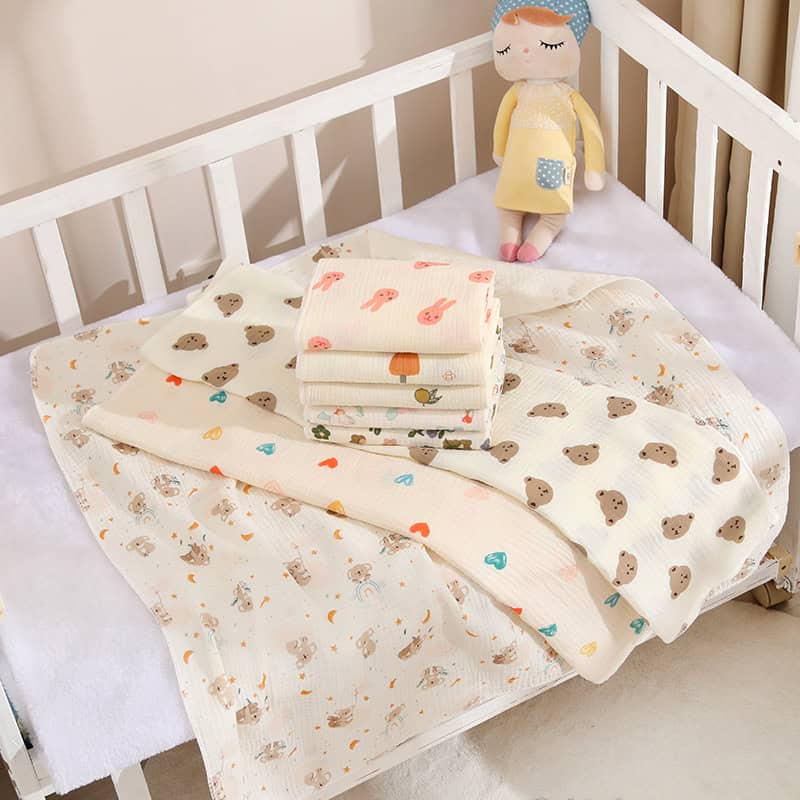 Soft baby blankets with adorable animal and heart patterns on a white crib bed, ideal for nursery bedding and cozy sleep for infants, from Monalisa Medical store.