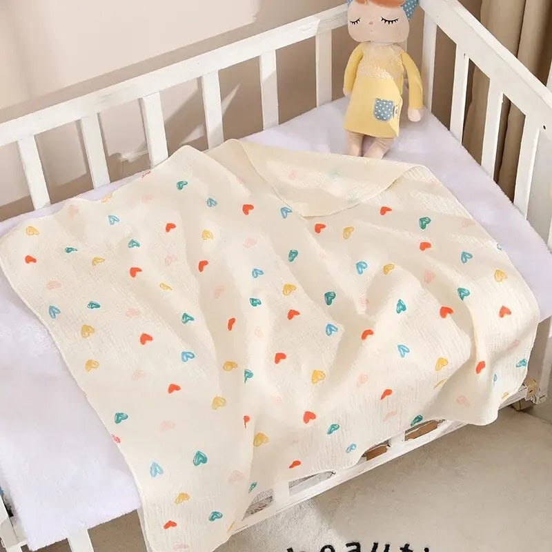 Colorful baby blanket with heart pattern on white crib, adorable plush doll, perfect for kids' bedroom decor, Monalisa Medical store.