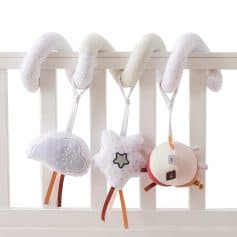 Soft plush baby crib toys with cloud, star, and moon designs hanging on a white crib rail, ideal for sensory development and baby’s nursery decor.