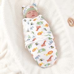 Baby sleeping in cute animal print swaddle blanket with matching hat at Monalisa Store.