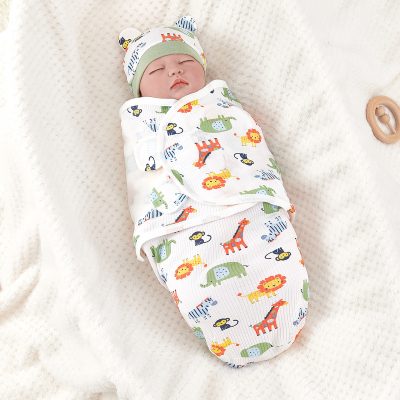 Baby sleeping in cute animal print swaddle blanket with matching hat at Monalisa Store.