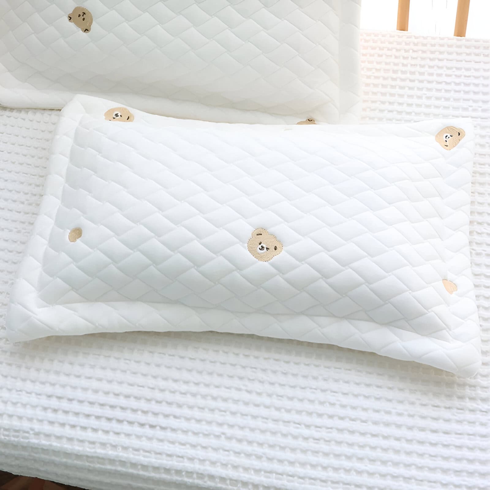 Soft white mattress with adorable bear embroidery, perfect for a cozy nursery or child's bedroom. Durable, comfortable, and designed for restful sleep for little ones.