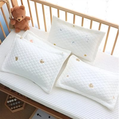 Soft white baby pillows with playful bear and star embroidered patterns, ideal for nursery bedding and sleep comfort. Perfect for infants and toddlers.