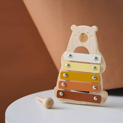 Colorful wooden bear-shaped xylophone toy for children, featuring vibrant bars and a mallet, perfect for early childhood music education and sensory development.