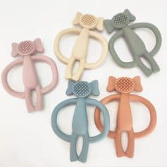 Colorful silicone baby teethers in various pastel shades including pink, beige, green, blue, and peach, designed for teething relief and sensory stimulation.