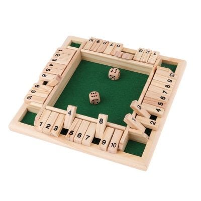 Colorful wooden Ludo game set with green playing surface, dice, and numbered pawns, perfect for family fun and entertainment.