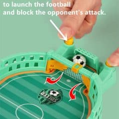 Toy soccer game with push-button launch mechanism for kids, featuring a miniature football and goal area. Fun, engaging sports game designed for children to simulate soccer matches indoors.