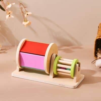 Red and pink wooden educational toy roller with green and natural wood accents for kids learning colors and motor skills.