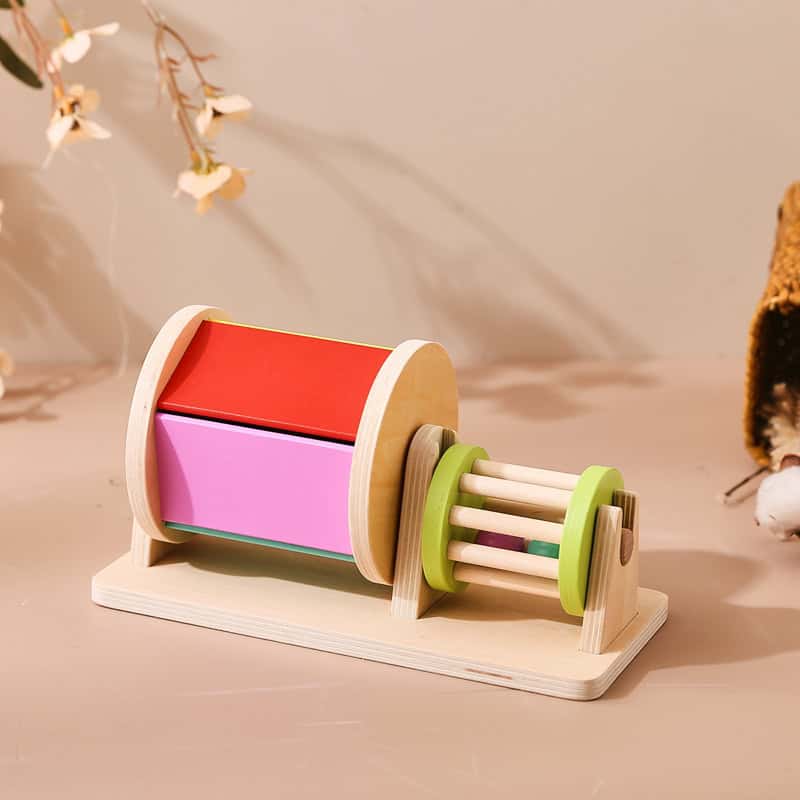 Red and pink wooden educational toy roller with green and natural wood accents for kids learning colors and motor skills.