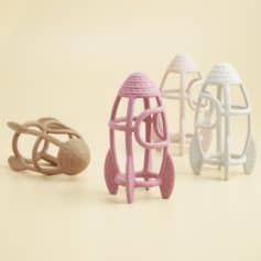 Colorful rubber baby teething toys shaped like rockets and spaceships for infants and toddlers. Perfect for soothing gums and promoting sensory development. Available at Monalisa Store.