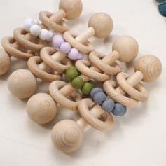 Natural wooden teething toys with colorful silicone beads for babies, safe and soothing teething accessories. Perfect for infant sensory development and dental comfort.