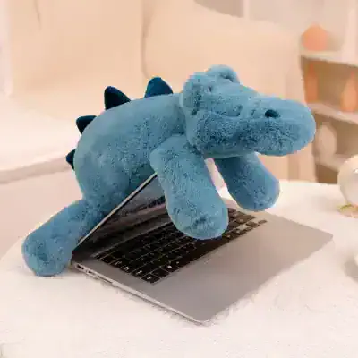 Blue stuffed dinosaur plushie on a laptop, cozy home decor, toy for kids and adults, playful office accessory, Monalisa Store.