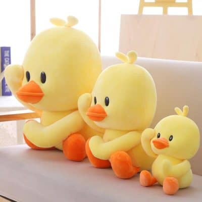 Large yellow duck plush toys with orange beaks and feet, perfect for kids' rooms and nurseries. Soft, cuddly, and adorable duck cushions for comfort and decoration.