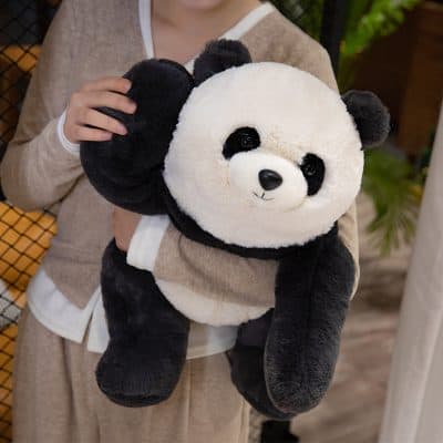 Cute plush panda bear toy held by a person, perfect for gifts or toys, made from soft materials, ideal for children and panda lovers.