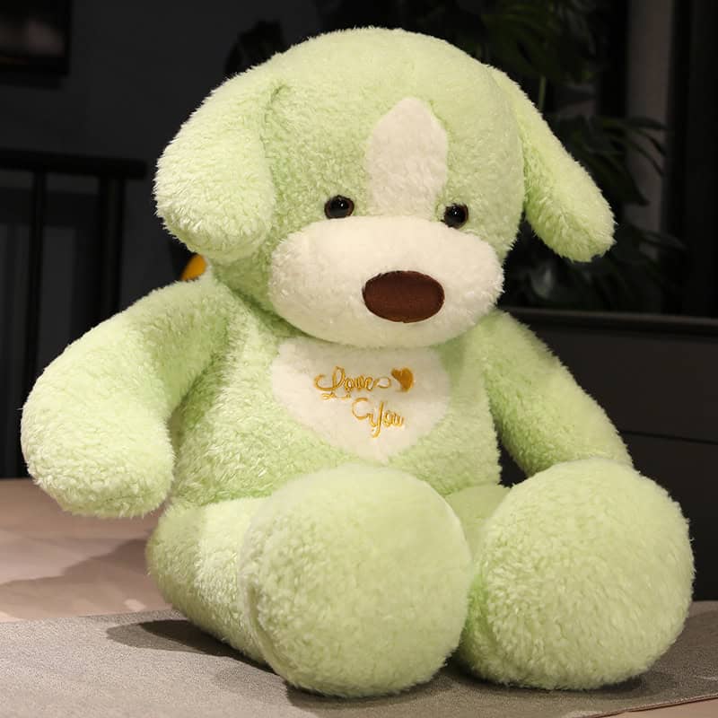 Cute green teddy bear plush toy with "Love You" embroidery, perfect for gifts, decor, or cuddling. Soft, huggable design ideal for children and loved ones.