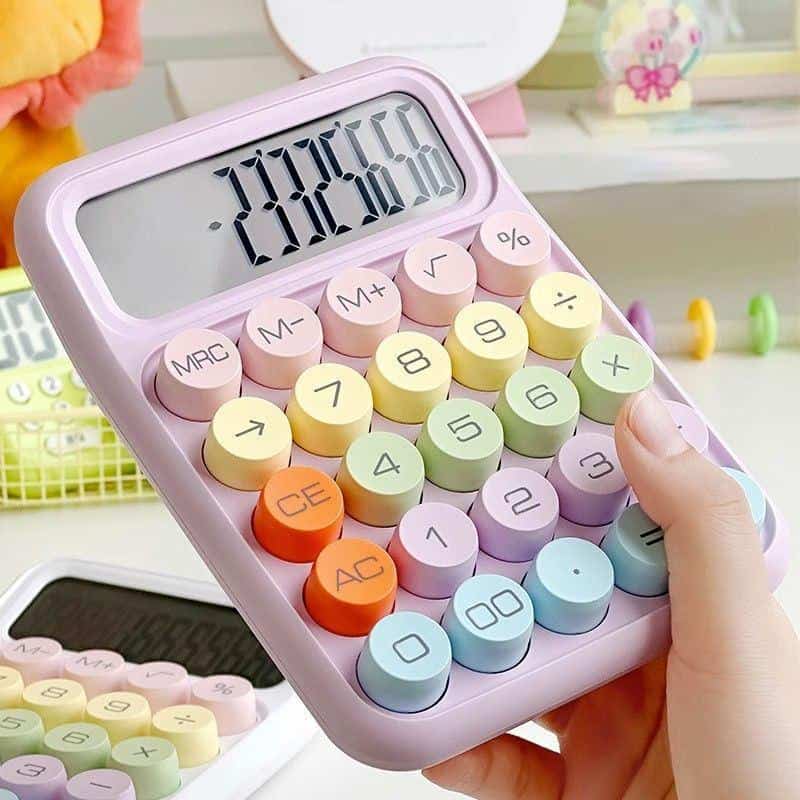 Pink calculator with pastel-colored buttons, close-up view.