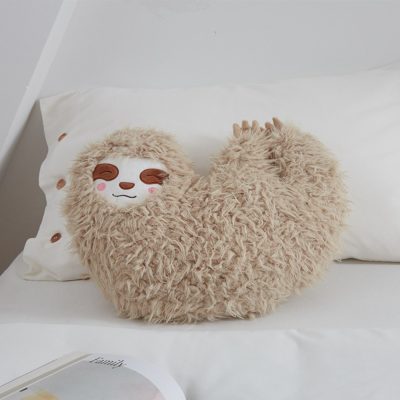 Soft plush sloth pillow with adorable embroidered face, perfect for kids' bedrooms, nurseries, and as a cozy decorative cushion for animal lovers.