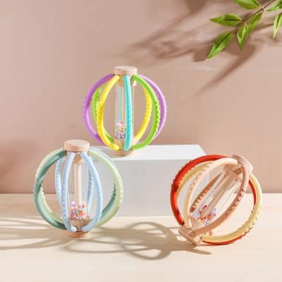 Colorful toy rattle with hanging beads, ideal for babies, soft silicone and wooden grip, entertaining and safe for infants.