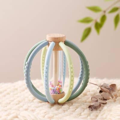 Flexible silicone teether with textured handles and colorful beads, ideal for soothing baby's gums. Perfect for infant teething relief and developmental comfort.