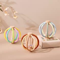 Colorful silicone baby teether toys with beaded center, suitable for infant teething relief. Bright pastel colors and soft textures make these safe, soothing sensory toys for babies.