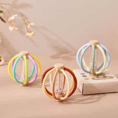 Colorful silicone baby teether toys with beaded center, suitable for infant teething relief. Bright pastel colors and soft textures make these safe, soothing sensory toys for babies.