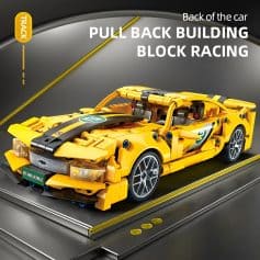 LEGO race car model with yellow and black details, detailed rear wing and realistic wheels, perfect for car enthusiasts and racing LEGO fans.