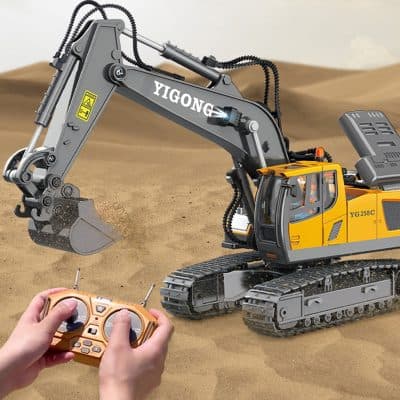 YIGONG remote-controlled excavator on sandy terrain, with a person holding a remote control in the foreground, showcasing modern construction machinery and remote operation technology.
