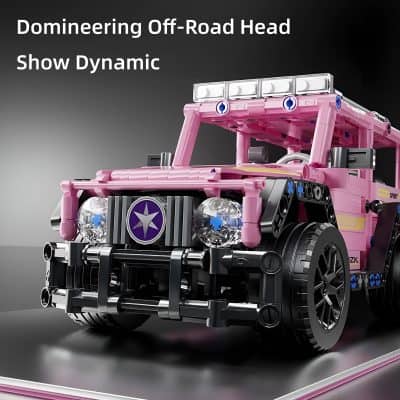 Miniature pink off-road vehicle constructed from LEGO bricks, detailed with LED headlights, black wheels, and intricate blue and gray accents, highlighting advanced LEGO building techniques and design.
