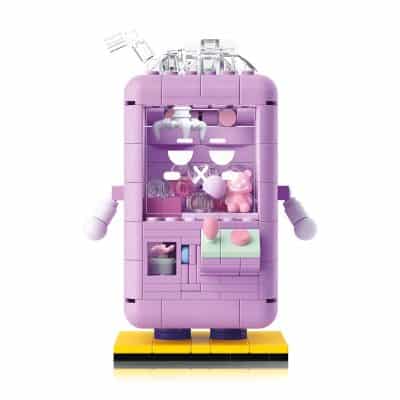Colorful LEGO-style robot toy in pastel pink and purple with expressive facial features, arms, and a display of small accessories, recommended for children’s entertainment and imaginative play.
