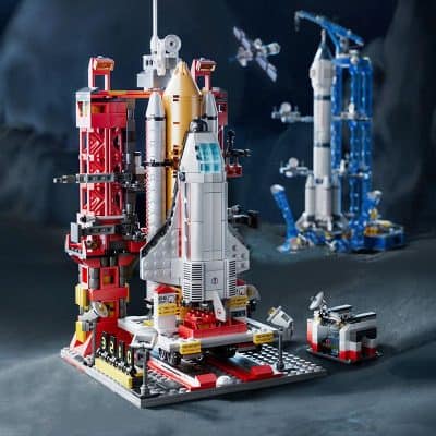 Detailed LEGO space rocket ship model on a launchpad with surrounding spacecraft and technical details at Monalisa Store, emphasizing innovative space exploration and LEGO building kits.
