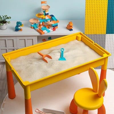 Colorful sandbox play table with beach-themed toys for kids' outdoor entertainment.