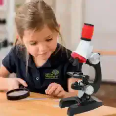 Children examining a microscope at Monalisa Store for educational science activities and optical learning.