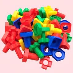 Neon-colored plastic wall anchors and screws for home improvement and drywall installation. Bright and durable wall mounting hardware in red, blue, green, and yellow. Perfect for DIY projects.
